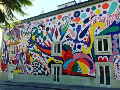 a building with a painting on the side of it at OHH - General da Silveira Flat Deluxe Apartment - Downtown in Porto