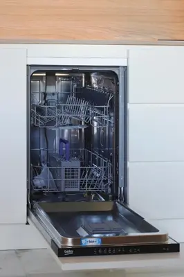 an open dishwasher with dishes inside of it at HM - Infante Riverside Apartment K in Porto