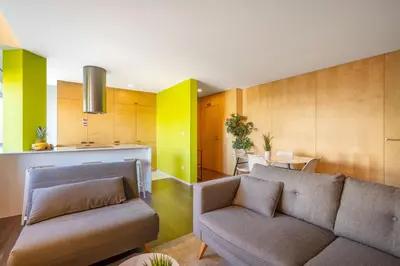 a living room with a couch and a kitchen at Host Wise - Restful Minimalist Flat - Balcony in Porto