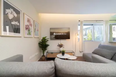 a living room with two couches and a tv at Host Wise - Restful Minimalist Flat - Balcony in Porto