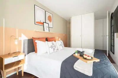 a bedroom with a bed with a tray on it at Host Wise - Restful Minimalist Flat - Balcony in Porto