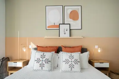a bedroom with a bed with two lamps and two pillows at Host Wise - Restful Minimalist Flat - Balcony in Porto