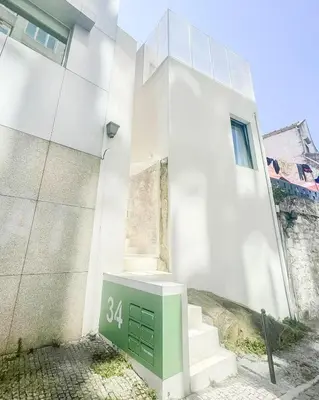 a white building with a green door and stairs at Duplex Apt - Sleeps 4 - Roof Terrace - Balcony in Porto