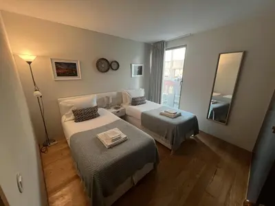 a hotel room with two beds and a mirror at Duplex Apt - Sleeps 4 - Roof Terrace - Balcony in Porto