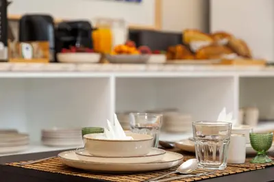 a table with plates and glasses on a counter at Casa Kala in Porto