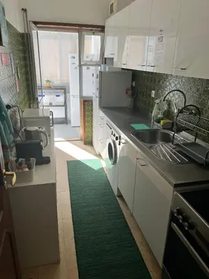 a kitchen with a sink and a washing machine at Pilar Hostel - Rua de Santa Catarina - Porto in Porto