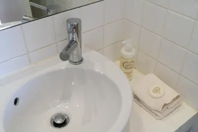 a white sink with a faucet on top of it at Belleville in Porto