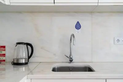 a kitchen counter with a sink and a mixer at Belleville in Porto