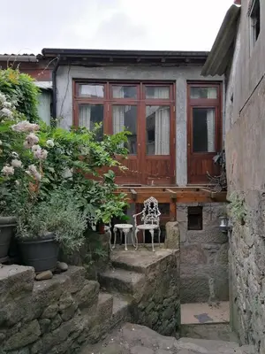 a house with a patio with two chairs and plants at Vérités Dame in Porto