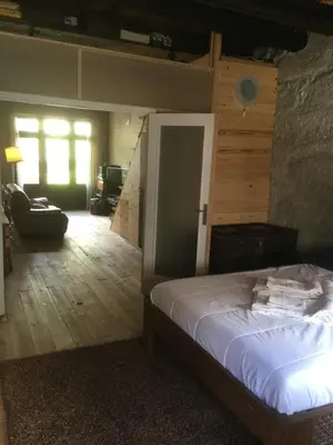 a bedroom with a bed and a living room at Vérités Dame in Porto