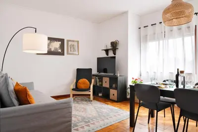 a living room with a table and a dining room at ! Luminous 2BR Top Floor ! Praça da República in Porto
