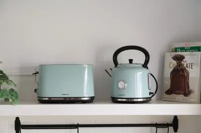 two toasters and a toaster sitting on a shelf at ! Luminous 2BR Top Floor ! Praça da República in Porto