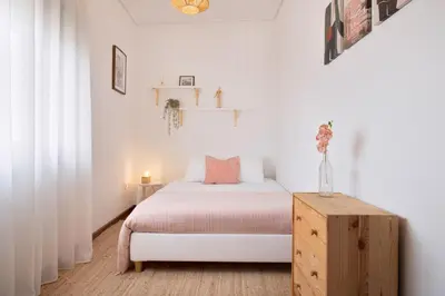 a white bedroom with a bed and a wooden cabinet at ! Luminous 2BR Top Floor ! Praça da República in Porto