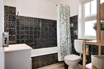a bathroom with a toilet and a shower at ! Luminous 2BR Top Floor ! Praça da República in Porto