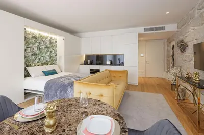 a living room with a couch and a bed at The Downtown Charming Apartments in Porto