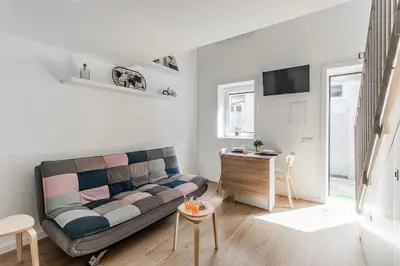 a living room with a couch and a table at Casa do Bonjardim, Lapa - Estadia no coração do Porto in Porto