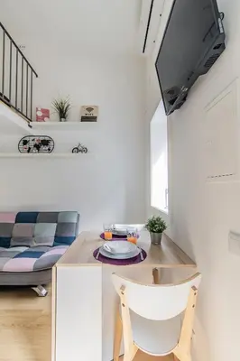 a living room with a table and a couch at Casa do Bonjardim, Lapa - Estadia no coração do Porto in Porto