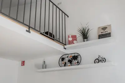 a staircase with white walls and white shelves at Casa do Bonjardim, Lapa - Estadia no coração do Porto in Porto