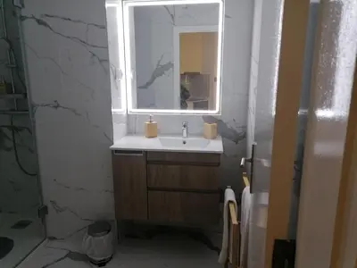 a bathroom with a sink and a mirror at TMJ Apartamento in Porto