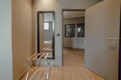a room with a mirror and a glass table at River Eyes Suites in Vila Nova de Gaia