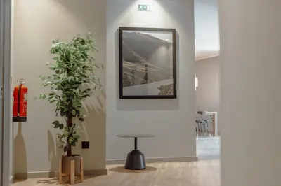 a room with a mirror and a plant in it at River Eyes Suites in Vila Nova de Gaia