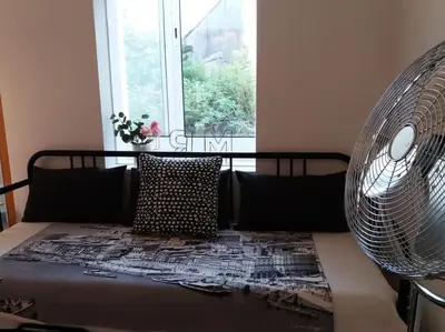 a bed in a room with a window and fan at KrisApartments 2 in Porto
