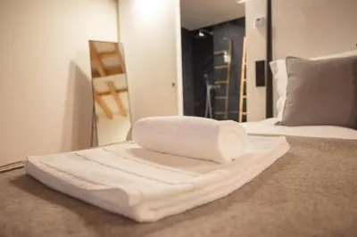 a pile of towels sitting on top of a bed at Loungy Porto in Porto