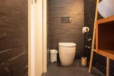 a bathroom with a white toilet in a room at Loungy Porto in Porto