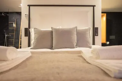 a bedroom with a large bed with white pillows at Loungy Porto in Porto