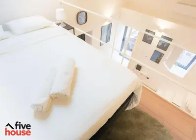 a bedroom with a large white bed with white pillows at FIVE HOUSE 16 in Porto