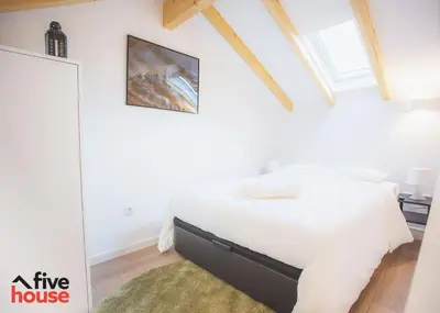 a bedroom with a bed in a white room at FIVE HOUSE 16 in Porto