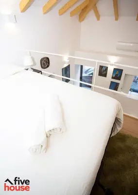 a bedroom with a large white bed with white pillows at FIVE HOUSE 16 in Porto