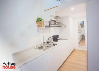 a kitchen with white cabinets and a sink at FIVE HOUSE 16 in Porto
