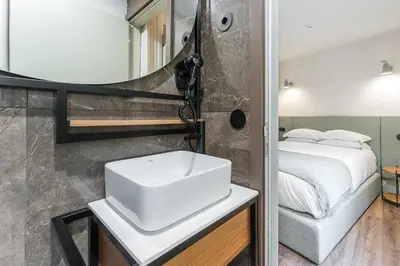 a bathroom with a sink and a mirror at GuestReady - Mercadores 150 in Porto