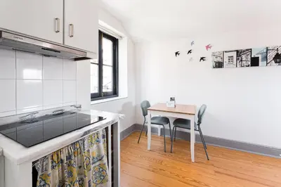 a kitchen with a table and chairs in a room at GuestReady - Modern Comfort in Downtown in Porto