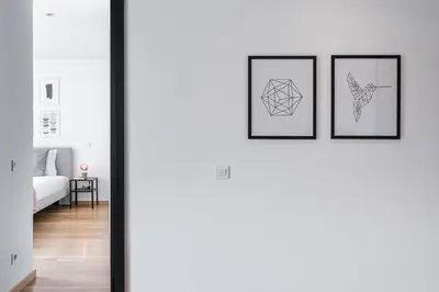 a room with three framed drawings on the wall at GuestReady - Poet's Modern Retreat in Porto