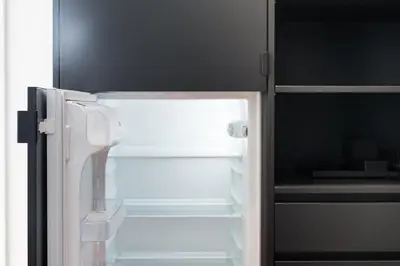 an empty refrigerator with its door open in a kitchen at GuestReady - Poet's Modern Retreat in Porto