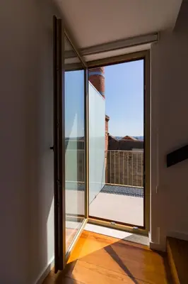 a sliding glass door with a view of a balcony at OHH- Padre António Vieira flat D - 2bedroom near the train station in Porto