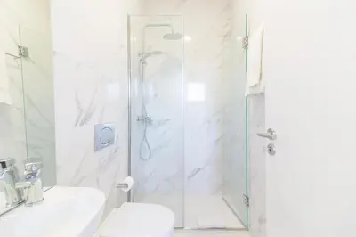 a bathroom with a shower and a toilet and a sink at OHH- Padre António Vieira flat D - 2bedroom near the train station in Porto