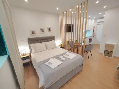 a bedroom with a bed with two towels on it at A Window to Porto – Premium Apartment Porto Downtown in Porto