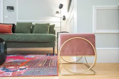 a living room with a couch and a chair at Cocoon Almada in Porto