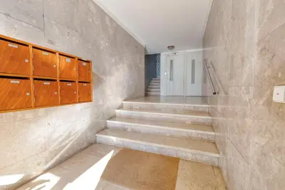 a staircase in a room with concrete walls and wooden cabinets at Travel & Live Bragas in Porto