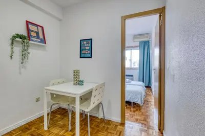 a room with a table and a bed and a mirror at Travel & Live Bragas in Porto