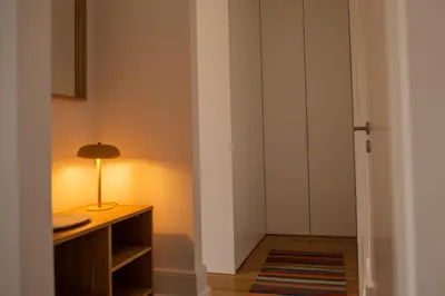 a room with a table and a lamp on a desk at Spacious Studio w/ Balcony & AC by LovelyStay in Porto