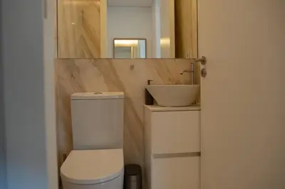 a bathroom with a toilet and a sink at Spacious Studio w/ Balcony & AC by LovelyStay in Porto