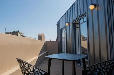 a table and two chairs on a balcony at Spacious Studio w/ Balcony & AC by LovelyStay in Porto