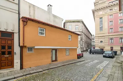 a small orange building on a city street at CHARM APARTMENTS PORTO - Centro Batalha 1 in Porto