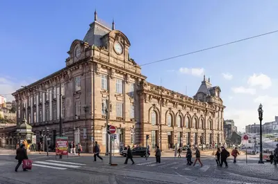 a large building with a clock tower on top of it at CHARM APARTMENTS PORTO - Centro Batalha 1 in Porto