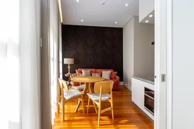 a dining room with a table and chairs and a couch at Mouzinho 129 - Sobreiro in Porto