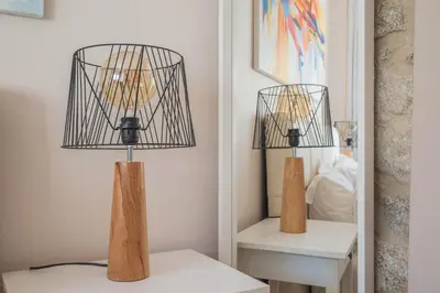 a lamp sitting on a table next to a mirror at PortoTile By RDC in Porto